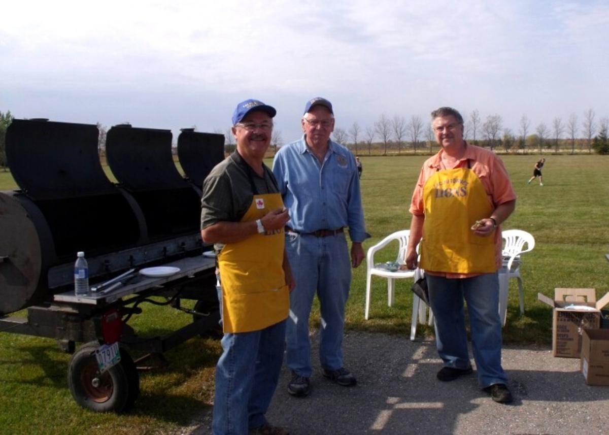 Photo of three Lac du Bonnet Lions volunteers getting ready to barbeque for an event.
