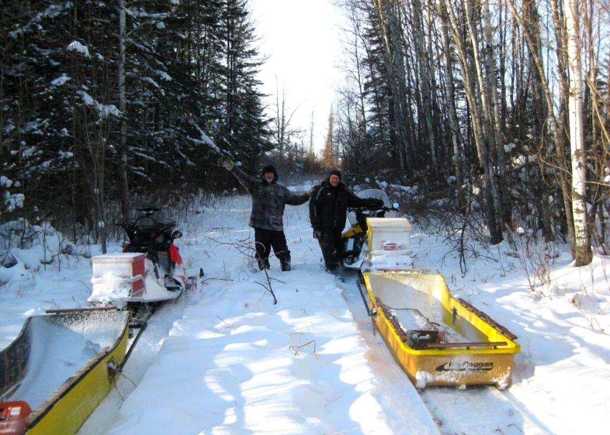 Photo of two men grooming one of Lee River Snow Riders' trails.
