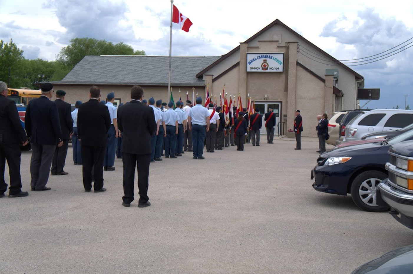 Photo of dozens of people dressed in uniform entering the Lac du Bonnet Legion in an orderly fashion.